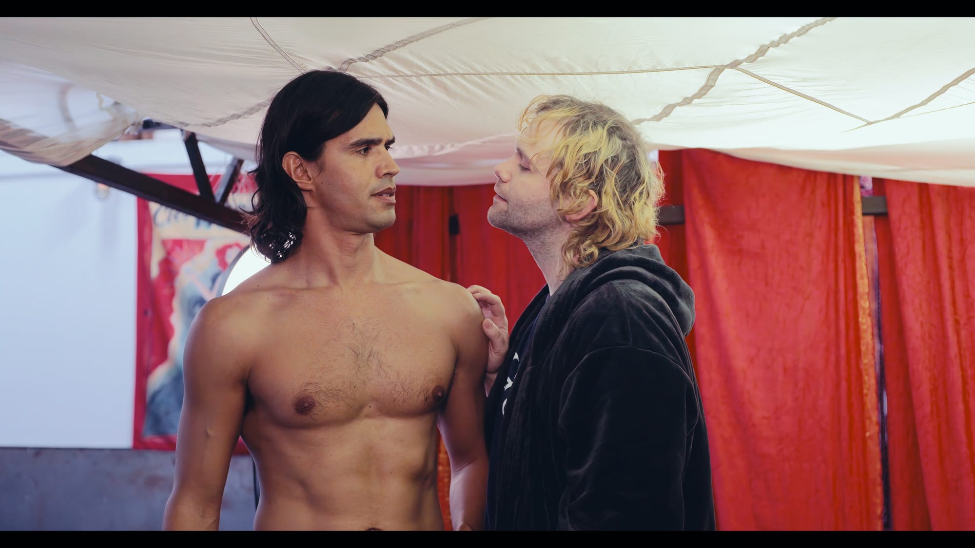 Ryan and Evan stand close together on the makeshift film set in Cutaways.